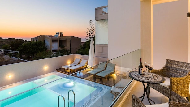 A rooftop pool area with lounge chairs and a table, overlooking a sunset. - Villa Amelia I Free Mini van Private Pool (Chania)