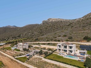A modern resort with multiple buildings, a swimming pool, and solar panels. - Villa Vista I Free Heated Pool Dazzling Seaview (Kissamos)
