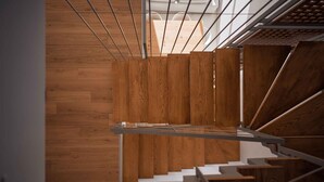 A modern staircase with wooden steps and metal railings, leading to a higher floor. - Omnia Villa I - Heated Pool Stunning Seaview (Chania)