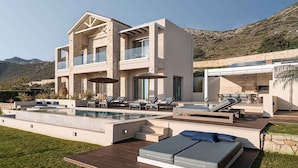 A modern two-story house with a swimming pool, outdoor seating, and a view of the mountains. - Villa Mare I Free Heated Pool Infinite Blue (Kissamos)