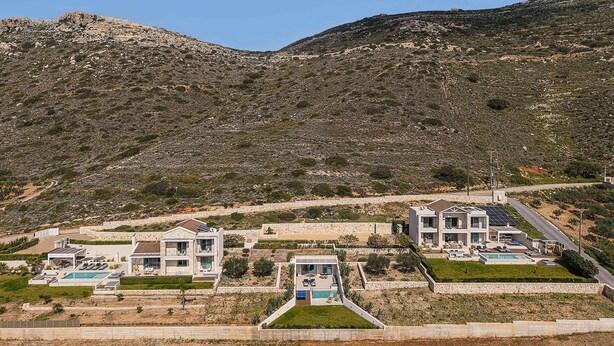 A hillside property with modern houses, a swimming pool, and a clear view of the surrounding landscape. - Villa Mare I Free Heated Pool Infinite Blue (Kissamos)