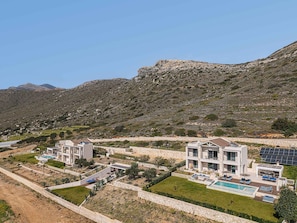 A modern resort with multiple buildings, a swimming pool, and solar panels. - Villa Cielo I Free Heated Pool Stunning Seaview (Kissamos)