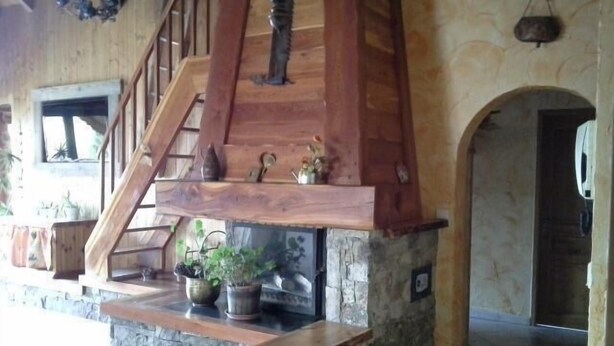 A wooden staircase with a stone base leading to a landing area with potted plants. - 3rd floor, balcony, ski locker, 145m², Valloire (Valloire)