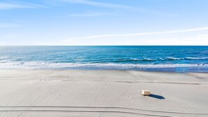 A beach with a clear sky and calm sea.