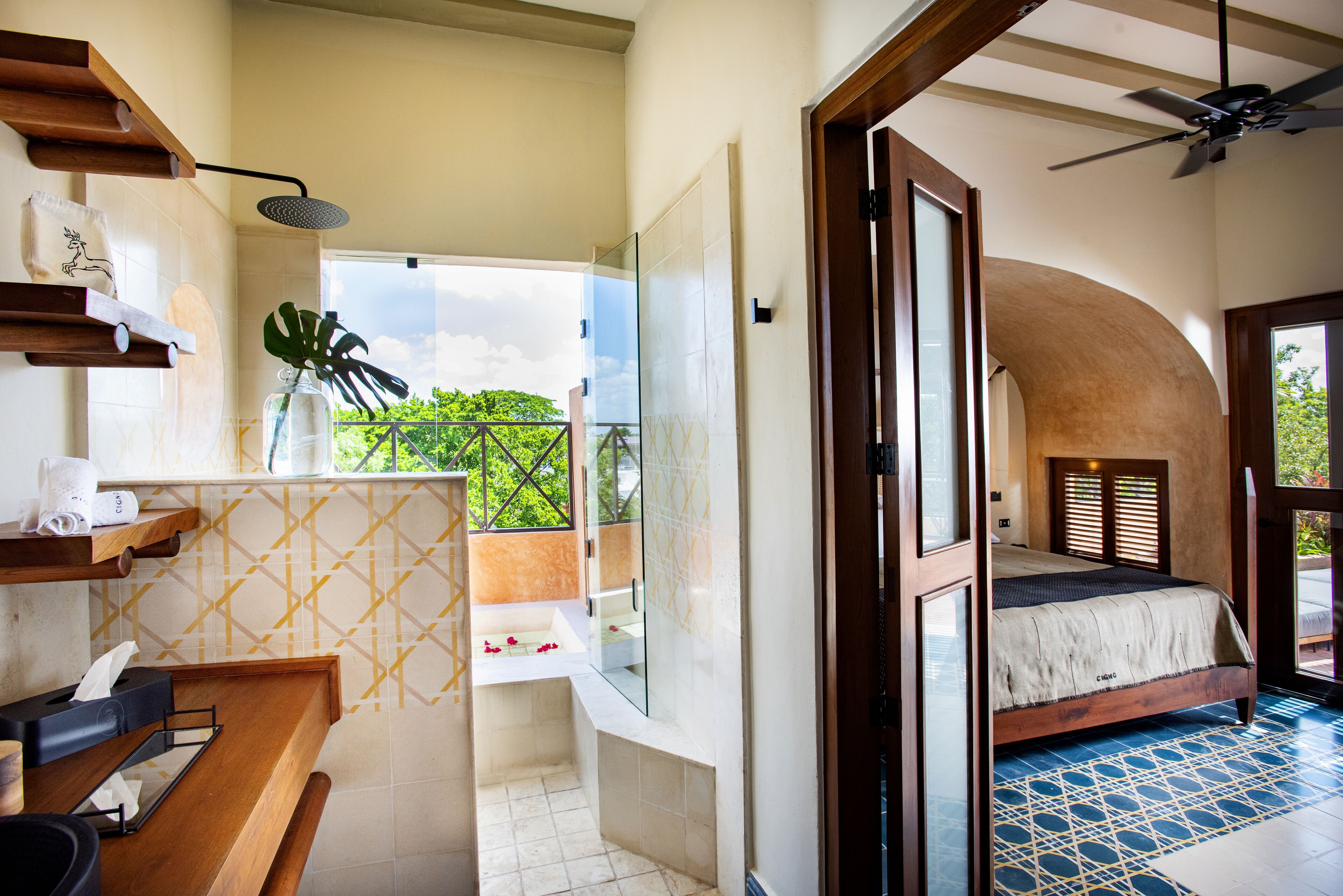A modern bathroom with a shower, a sink, and a glass-enclosed window.