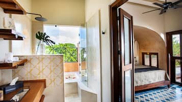 A modern bathroom with a shower, a sink, and a glass-enclosed window.