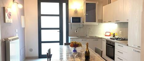 Fridge, microwave, stovetop, coffee/tea maker