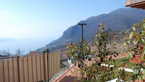 A balcony with a view of a mountain and a town below.