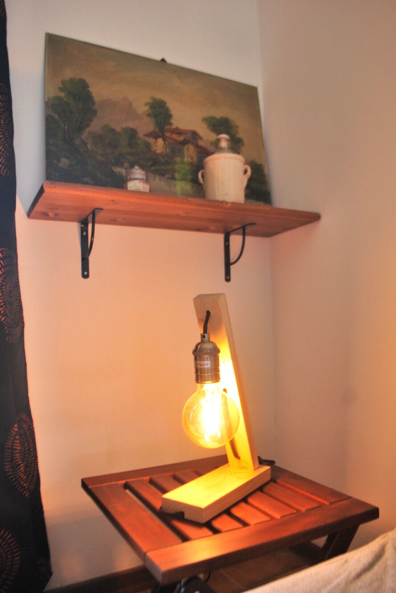 A wooden table with a hanging light fixture.