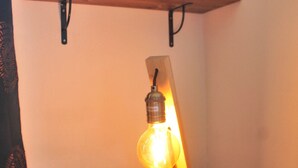 A wooden table with a hanging light fixture. - Nadia by Theater Home, with garden and marvellous lake view (Tignale)