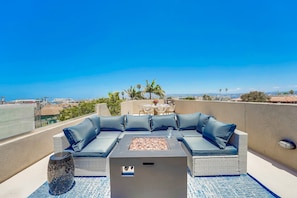 Relax on the rooftop with a comfortable sofa and enjoy the city views from this outdoor seating area.