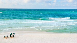 A beach with a row of beach chairs and a single umbrella. - 🐟350yds 2 Beach-Porch-Magnolia Cottage (Inlet Beach)