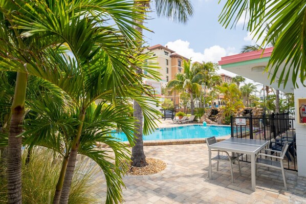 Relax by the pool surrounded by palm trees and enjoy the view from the comfort of your own space.