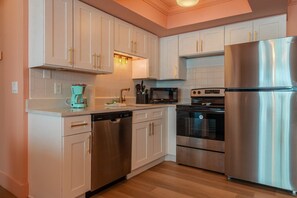Enjoy cooking in this well-equipped kitchen with a dishwasher, microwave, oven, and refrigerator.