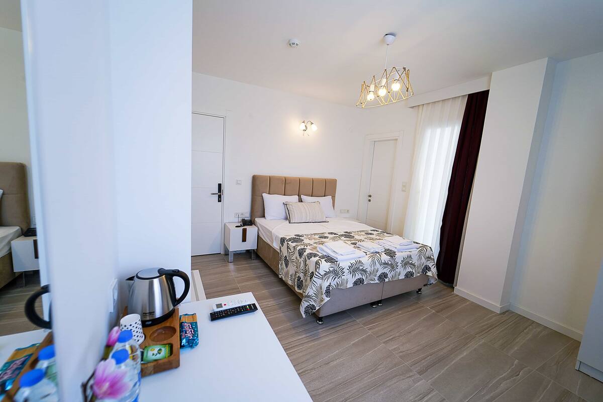 A modern bedroom with a bed, bedside table, and a nightstand.