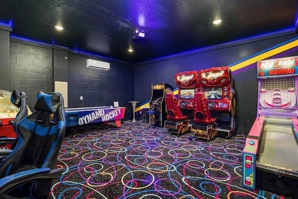 Experience endless fun in this vibrant game room featuring racing games, air hockey, and skee-ball, perfect for all ages.
