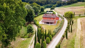 A red villa with a garden, surrounded by tall cypress trees and a winding road. - Villa Consolata, Large country villa with pool (Reggello)