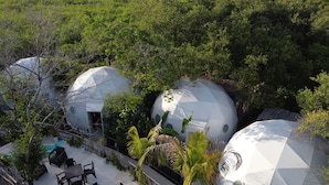 A resort with geodesic dome structures surrounded by lush greenery. - Chiibal Uh (Tulum)