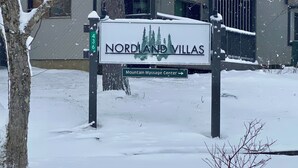 A sign for Nordland Villas with a direction to the Mountain Massage Center. - Smooth 2-minute ski to Lift Ski-in Ski-out • Smuggs Condo ⭐️  (Jeffersonville)