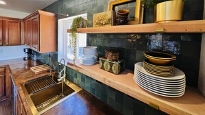 A kitchen with wooden cabinets, a stainless steel sink, and a backsplash with dark tiles. - Hillside Home: Amazing Views w/ Big Deck 5 Min. From Downtown + Trailheads! (Flagstaff)