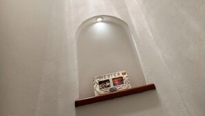 A narrow hallway with a small alcove containing a framed picture.