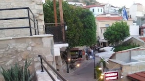 A street view with a restaurant named "Hideaway Restaurant" and a stone building with a balcony. - Immaculate 4-bed House in Pissouri (Pissouri)