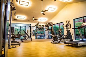 A gym with treadmills, stationary bikes, and weight machines. - Pigeon Forge | Friends' Outdoor Escape | Hiking + Pool | 2BR Townhome (Pigeon Forge)