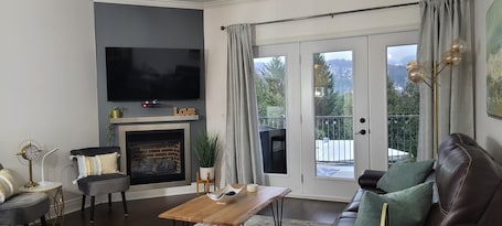 Comfort Condo | Living area | 50-inch TV with cable channels, DVD player