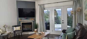 Comfort Condo | Living area | 50-inch TV with cable channels, DVD player