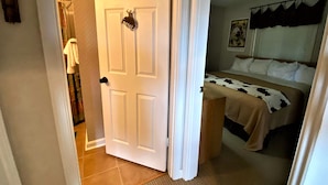 A bedroom with a bed, a door, and a shower area. - BR260 Perfect for 2 couples! Close to Towns. (Davis)