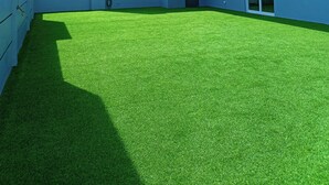 A modern building with a flat roof, large windows, and a grassy courtyard. - Alvea Hotel (Puerto Princesa)