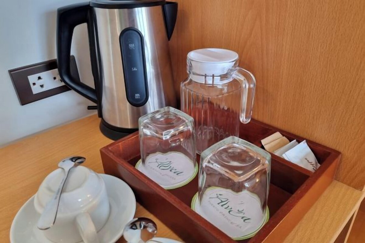 A tray with tea sets and a kettle, suggesting a tea service setup.