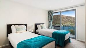 A hotel room with two beds, a large window with a view of a lake and mountains, and a balcony. - Lakeview Retreat - Queenstown Holiday Home (Queenstown)
