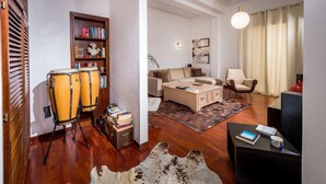 A modern living room with a sofa, coffee table, and a bookshelf. - Casa dei Mori by Interhome (Terrasini)