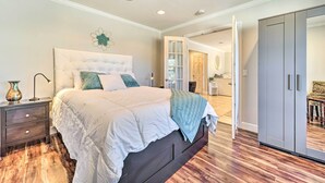 A bedroom with a large bed, a nightstand, a dresser, and a wardrobe. - Scenic Mancos Hideaway < 2 Mi to Mesa Verde! (Mancos)