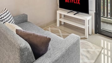 Apartment, 2 Bedrooms, City View | Living area | 43-inch Smart TV with cable channels, TV, Netflix