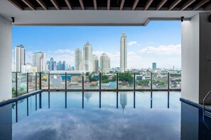 An indoor swimming pool with a cityscape view. - AKASA by Kozystay (Jakarta)