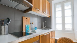 A modern kitchen with a built-in stove, a sink, and wooden cabinets. - House for 2 adults & 2 kids, central Ars-en-Ré (Ars-en-Ré)