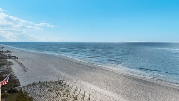 A beach with a wooden walkway and a flag. - Sandy Key 716: 2 BR / 2 BA Gulf Front Condo in Perdido Key, FL.  Sleeps 6 (Pensacola)