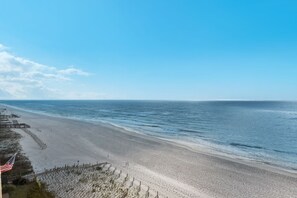 A beach with a wooden walkway and a flag. - Sandy Key 716: 2 BR / 2 BA Gulf Front Condo in Perdido Key, FL. Sleeps 6 (Pensacola)