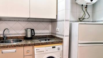 Fridge, microwave, coffee/tea maker, cookware/dishes/utensils