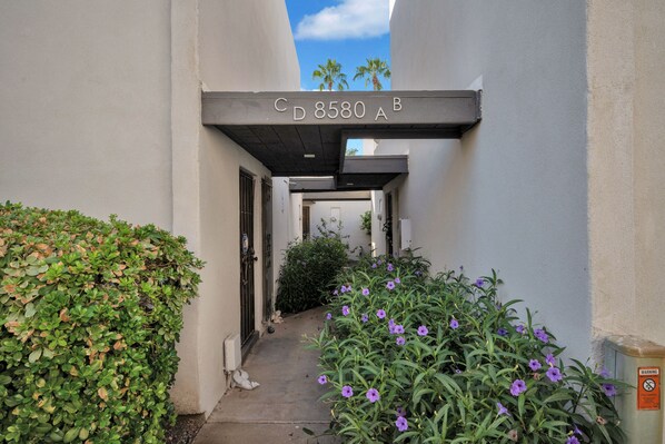 A narrow alleyway with a concrete overhang displaying the address "CD 8580 A B".