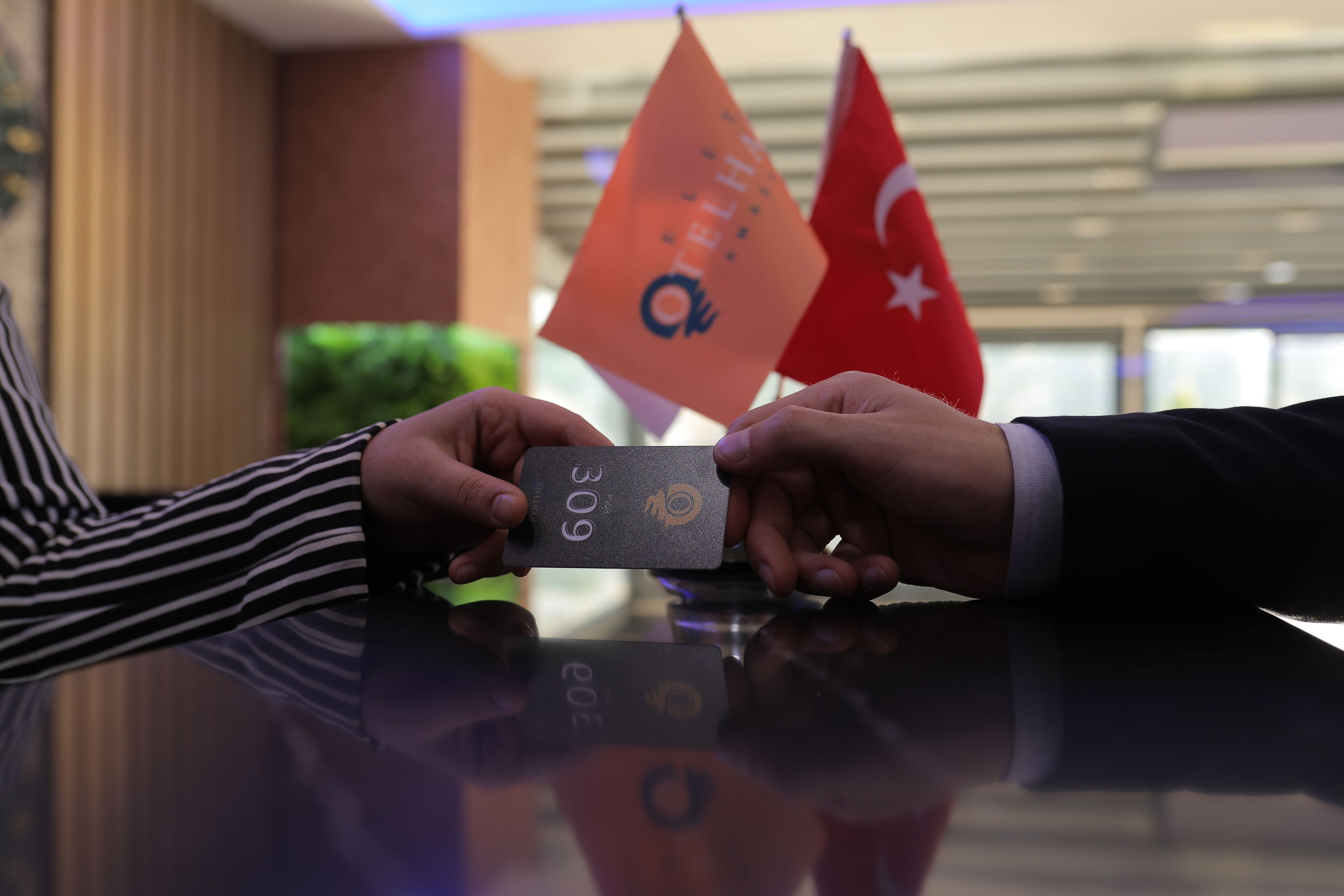 Two hands exchanging a card with the number 309.