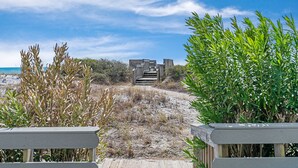 A sandy beach path leading to a wooden structure with steps, surrounded by green foliage. - Gulf View Townhome | Prime Beach Location, Walk to Multiple Restaurants! (Santa Rosa Beach)