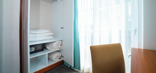 A hotel room with a closet containing folded towels and a television. - Hotel Camyuva Beach (Kemer)