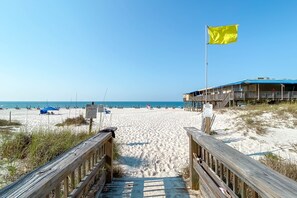 Walk along the boardwalk to the beach, where a flag marks the property boundary.