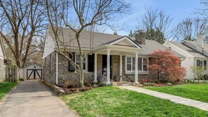 A residential house with a stone facade, a front porch, and a driveway leading to a garage. - Cute bungalow located in the Fairwood  neighborhood of Lexington. #15081244-1 (Lexington)
