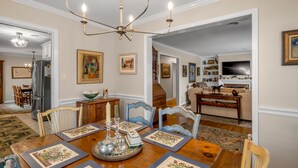 A dining area with a chandelier, wooden table, chairs, and a chandelier. - Cute bungalow located in the Fairwood  neighborhood of Lexington. #15081244-1 (Lexington)