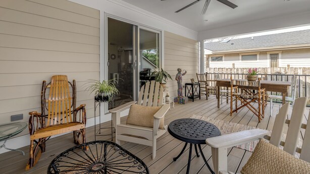 A covered outdoor area with wooden furniture, a ceiling fan, and a view of the house in the background. - Cute bungalow located in the Fairwood  neighborhood of Lexington. #15081244-1 (Lexington)