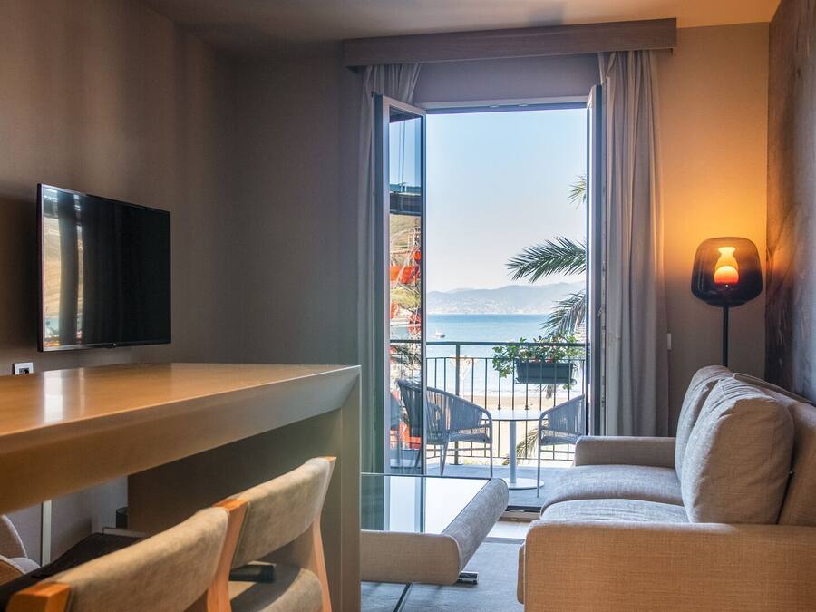 Suite bilocale, balcone, vista mare sulla Baia delle Favole | Area soggiorno | Smart TV 50 pollici con canali digitali, TV
